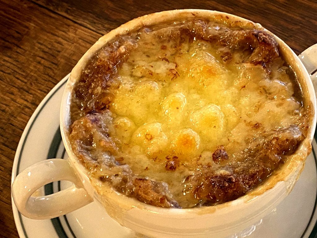 Soupe à l'oignon gratinée en bol, recouverte d'une croûte de fromage fondu doré